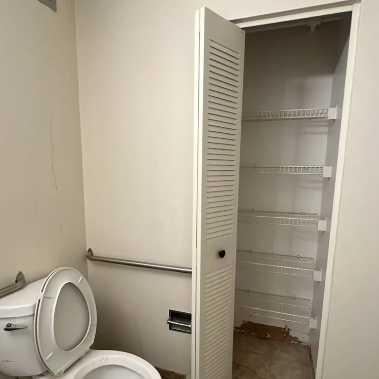 Bathroom cleared out with the floor swept after the cleanout