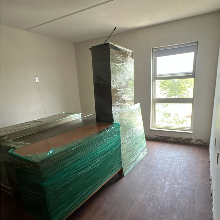 Emptied room with bare hardwood floor after the cleanout